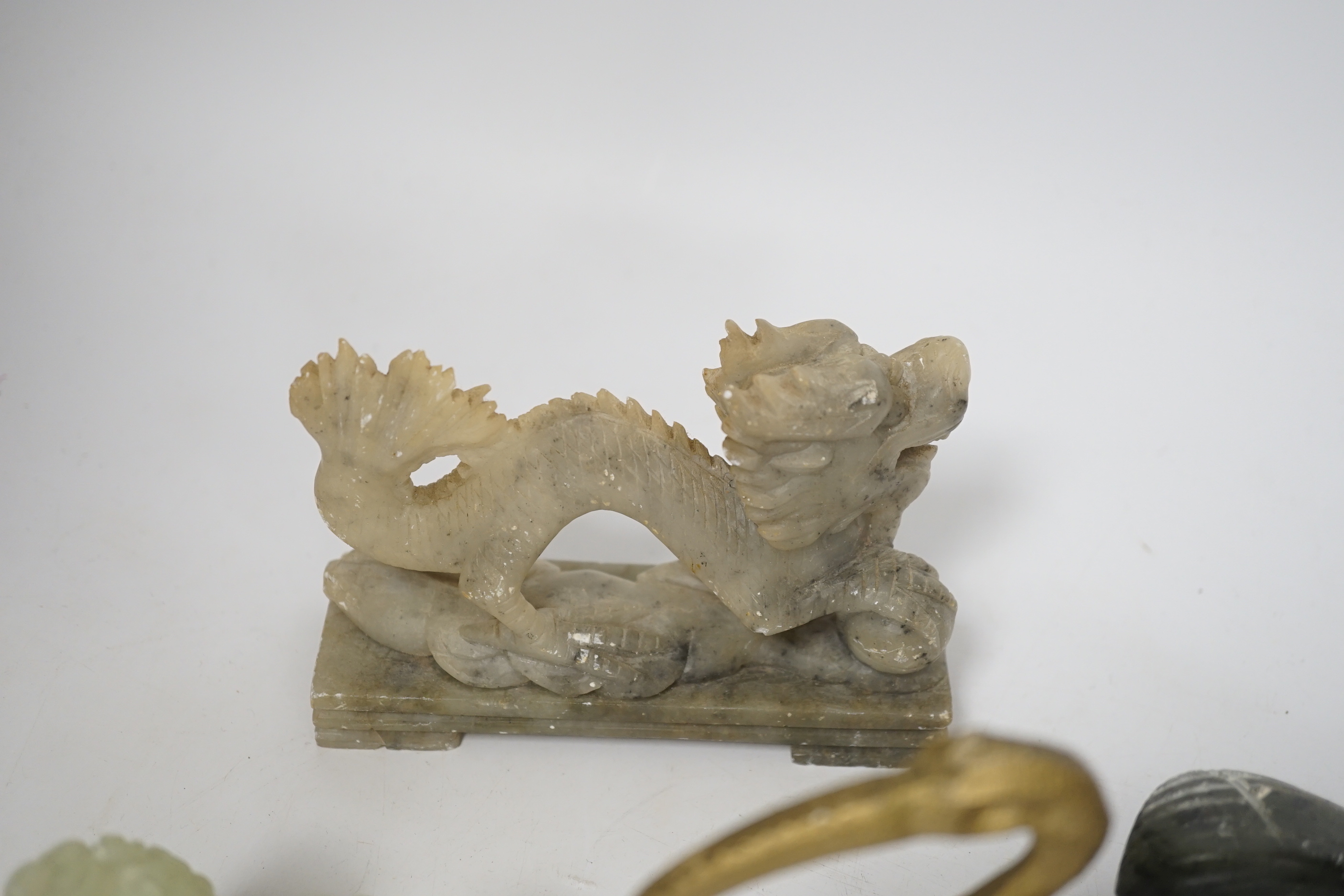 A group of Chinese soapstone and bowenite animal figures and a figural seal, largest 25cm wide (8)